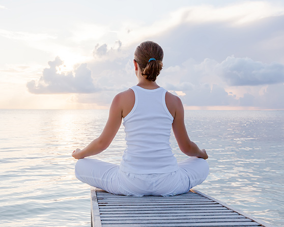 Woman meditating and learning strategies for coping with health issues